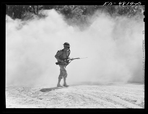 Untitled photo, possibly related to: Edgewood Arsenal, Maryland. Gas demonstration. Soldiers walking through a smoke screen
