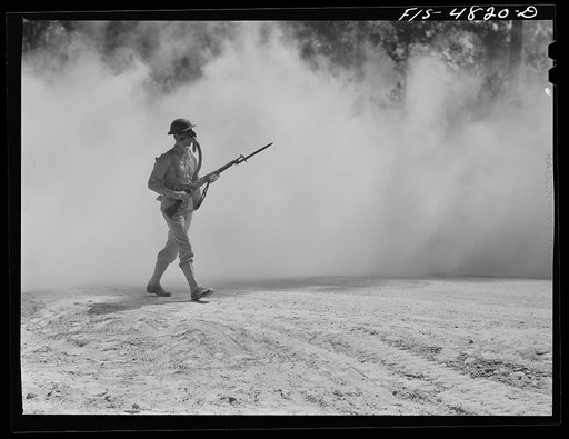 Untitled photo, possibly related to: Edgewood Arsenal, Maryland. Gas demonstration. Soldiers walking through a smoke screen