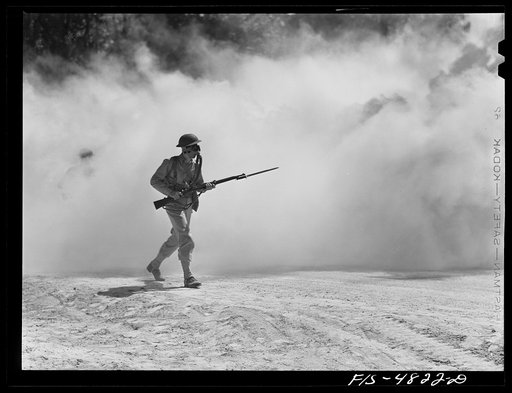 Untitled photo, possibly related to: Edgewood Arsenal, Maryland. Gas demonstration. Soldiers walking through a smoke screen