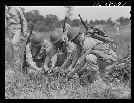 Edgewood Arsenal, Maryland. Gas demonstration. Mortar crew removing caps from shells which they are about to fire