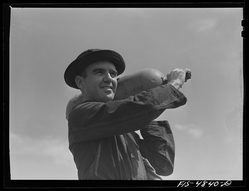 Edgewood Arsenal, Maryland. Gas demonstration. Soldier with one of the gas shells for Livens projectors