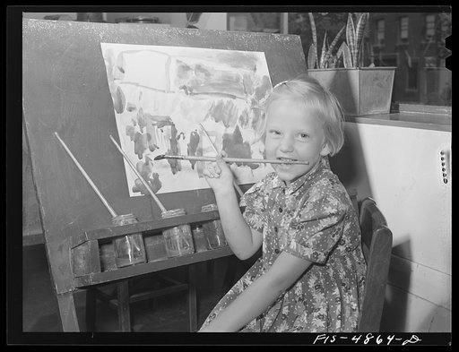 Brooklyn, New York. Red Hook housing development. Child painting in nursery at the community center