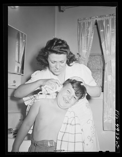 Untitled photo, possibly related to: Brooklyn, New York. Red Hook housing project. Mrs. Caputo fixes her three-year-old daughter's hair