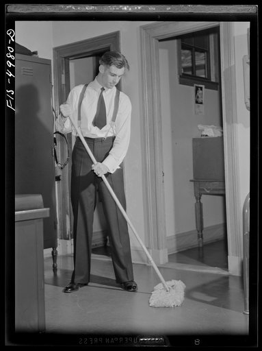 U.S. Naval Academy, Annapolis, Maryland. Midshipman cleaning the floor of his room
