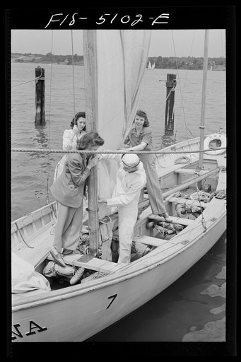 U.S. Naval Academy, Annapolis, Maryland. Midshipmen and their girls starting on a sailing trip in a "knockabout"