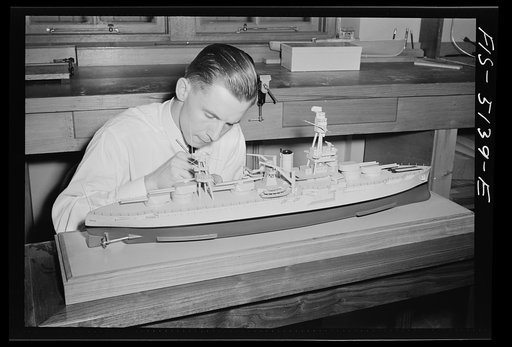 Untitled photo, possibly related to: U.S. Naval Academy, Annapolis, Maryland. Midshipman studying a ship's model