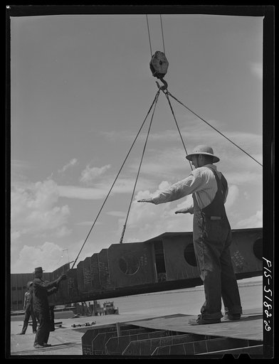 Decatur, Alabama. Ingalls Shipbuilding Company. Lowering into place a section of the barge's doublebottom. This signal means "hold it"