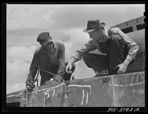 Decatur, Alabama Ingalls Shipbuilding Company. "Tacker" discussing a job with the foreman on one of the barges