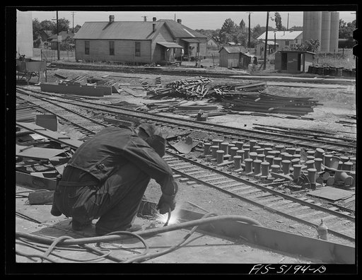 Untitled photo, possibly related to: Decatur, Alabama. Ingalls Shipbuilding Company. A welder at work on the deck of one of the barges