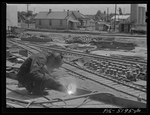 Decatur, Alabama. Ingalls Shipbuilding Company. A welder at work on the deck of one of the barges
