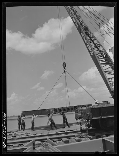 Decatur, Alabama. Ingalls Shipbuilding Company. A section of a ship's bottom being lowered into place