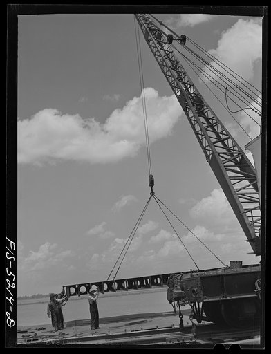 Untitled photo, possibly related to: Decatur, Alabama. Ingalls Shipbuilding Company. A section of a ship's bottom being lowered into place
