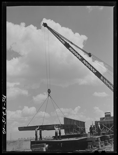 Untitled photo, possibly related to: Decatur, Alabama. Ingalls Shipbuilding Company. A section of a ship's bottom being lowered into place