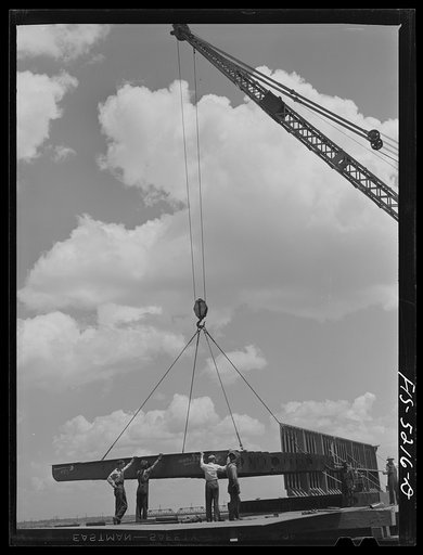 Untitled photo, possibly related to: Decatur, Alabama. Ingalls Shipbuilding Company. A section of a ship's bottom being lowered into place