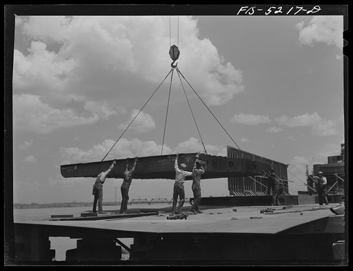 Decatur, Alabama. Ingalls Shipbuilding Company. A section of a ship's bottom being lowered into place