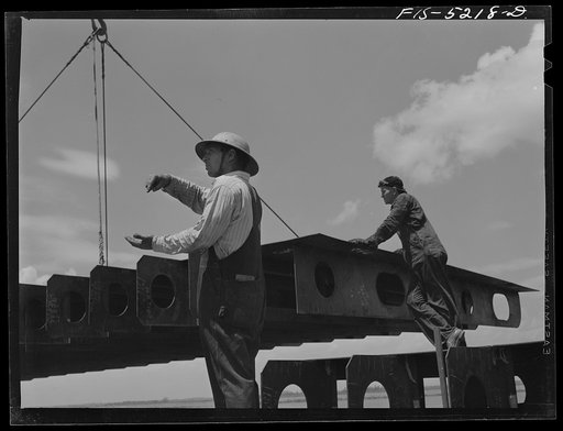 Decatur, Alabama. Ingalls Shipbuilding Company. A section of a ship's bottom being lowered into place. The signal means "let'er down easy"