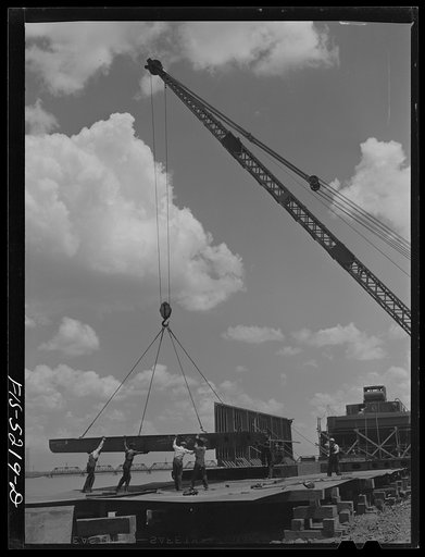 Decatur, Alabama. Ingalls Shipbuilding Company. A section of a ship's bottom being lowered into place