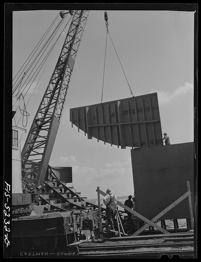 Decatur, Alabama. Ingalls Shipbuilding Company. Lowering into place one of the sides of the stern of a barge under construction