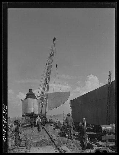 Decatur, Alabama. Ingalls Shipbuilding Company. Lowering into place one of the sides of the stern of a barge under construction
