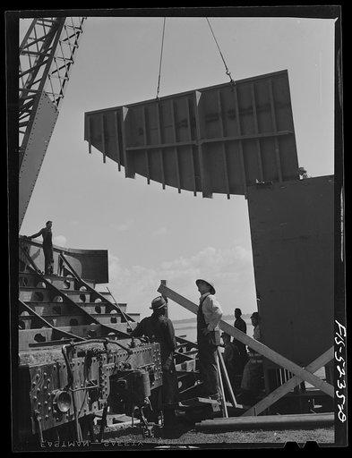 Decatur, Alabama. Ingalls Shipbuilding Company. Lowering into place one of the sides of the stern of a barge under construction