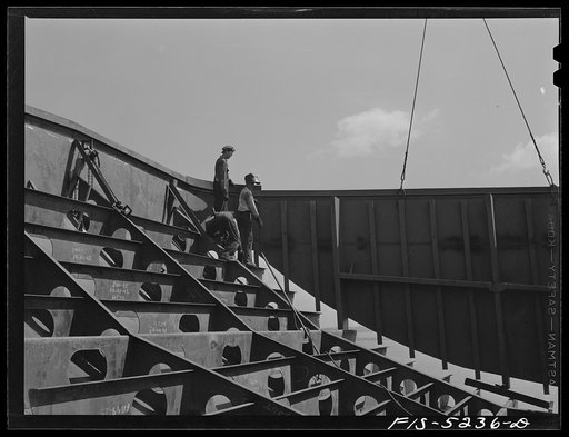 Decatur, Alabama. Ingalls Shipbuilding Company. Lowering into place one of the sides of the stern of a barge under construction