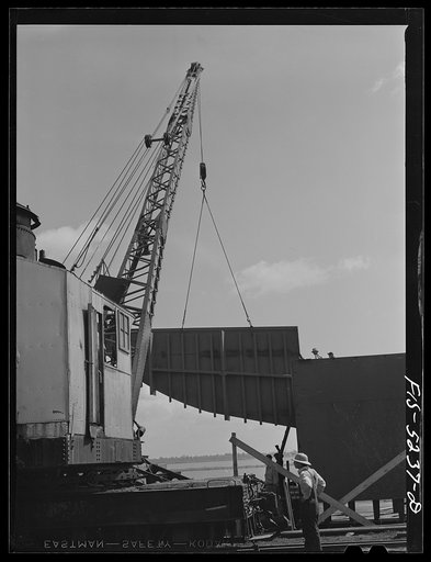 Untitled photo, possibly related to: Decatur, Alabama. Ingalls Shipbuilding Company. Lowering into place one of the sides of the stern of a barge under construction