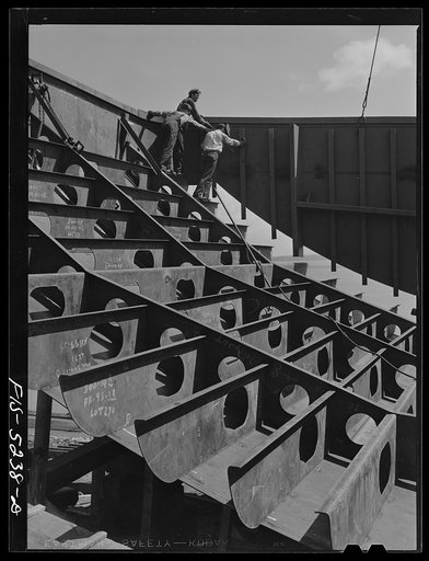 Decatur, Alabama. Ingalls Shipbuilding Company. Lowering into place one of the sides of the stern of a barge under construction