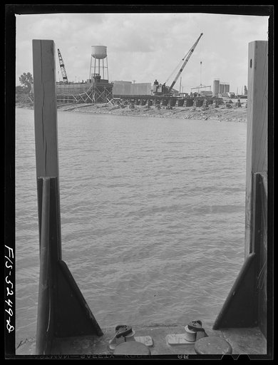 Untitled photo, possibly related to: Decatur, Alabama. Ingalls Shipbuilding Company. On the Tennessee River. From the yard the barges go down the river to Paducah, Kentucky, then down the Mississippi to New Orleans