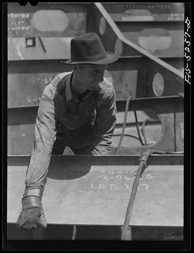 Decatur, Alabama. Ingalls Shipbuilding Company. A welder's assistant
