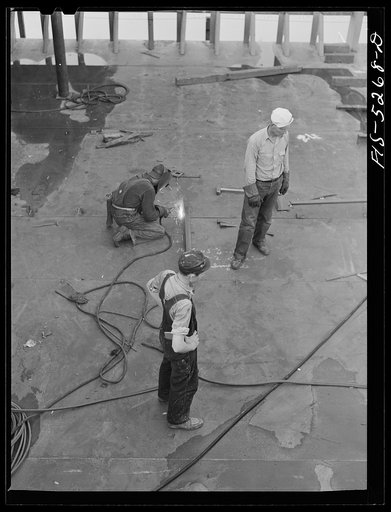 Decatur, Alabama. Ingalls Shipbuilding Company. Welder working on the bottom of one of the holds of a barge