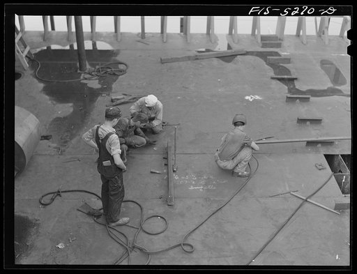 Untitled photo, possibly related to: Decatur, Alabama. Ingalls Shipbuilding Company. Welder working on the bottom of one of the holds of a barge