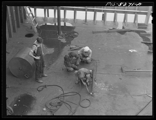Untitled photo, possibly related to: Decatur, Alabama. Ingalls Shipbuilding Company. Welder working on the bottom of one of the holds of a barge