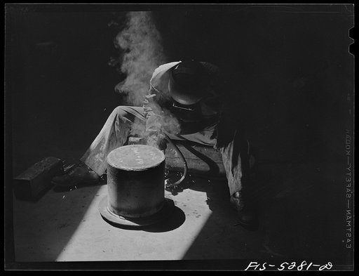 Untitled photo, possibly related to: Decatur, Alabama. Ingalls Shipbuilding Company. Welder working on the bottom of one of the holds of a barge