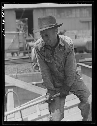 Untitled photo, possibly related to: Decatur, Alabama. Ingalls Shipbuilding Company. A welder's assistant