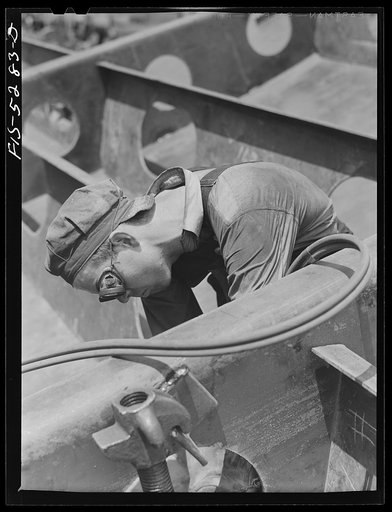 Decatur, Alabama. Ingalls Shipbuilding Company. A "tacker" working on a barge