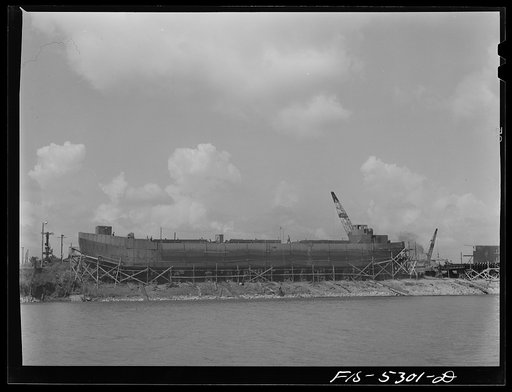 Untitled photo, possibly related to: Decatur, Alabama. Ingalls Shipbuilding Company. On the Tennessee River. From the yard the barges go down the river to Paducah, Kentucky, then down the Mississippi to New Orleans