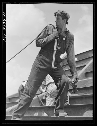 Untitled photo, possibly related to: Decatur, Alabama. Ingalls Shipbuilding Company. A tacker working on oe of the barges