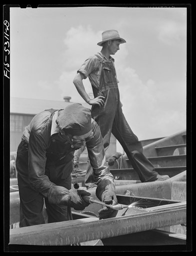 Decatur, Alabama. Ingalls Shipbuilding Company. A tacker working on one of the barges