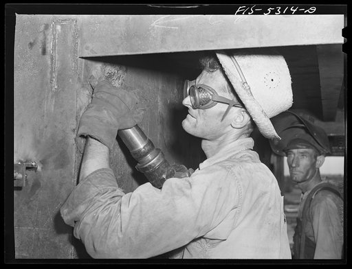 Decatur, Alabama. Ingalls Shipbuilding Company. A chipper at work in the wheelhouse of a barge