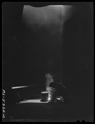 Untitled photo, possibly related to: Decatur, Alabama. Ingalls Shipbuilding Company. A welder working in the bottom on one of the barges