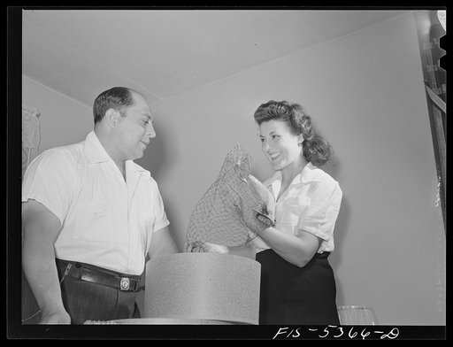 Brooklyn, New York. Red Hook housing development. Mrs. Caputo showing her husband a new hat