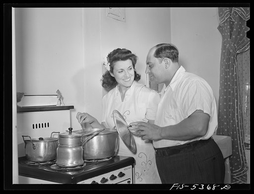 Brooklyn, New York. Red Hook housing development. Mr. Caputo watching his wife cook dinner