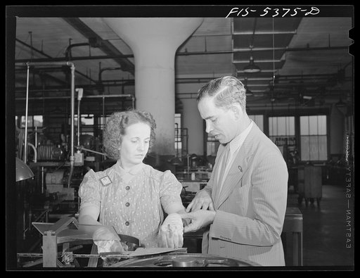 Brooklyn, New York. Physician examining a factory worker for occupational injury