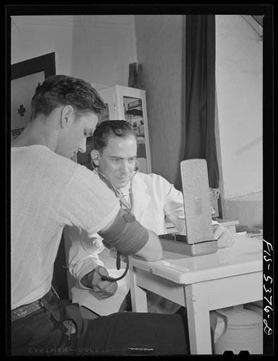 Brooklyn, New York. State physician checking the blood pressure of a factory worker