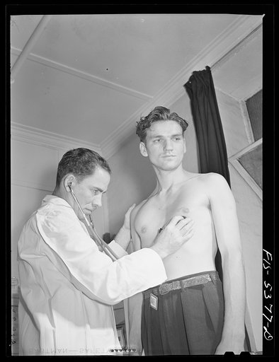 Brooklyn, New York. State industrial hygiene physician examining the heart of a factory worker