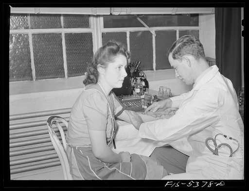 Brooklyn, New York. State physician giving a blood test to a girl factory worker