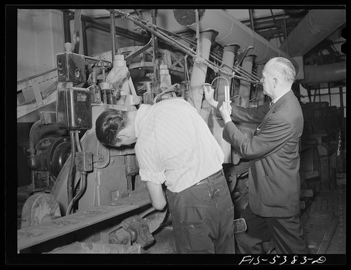 Brooklyn, New York. Ventilating engineer testing safety devices in a factory