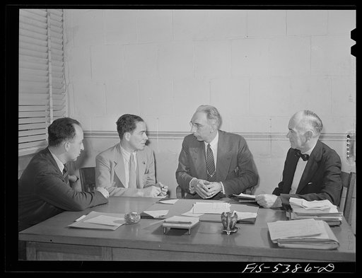 Brooklyn, New York. State industrial hygiene crew meeting with a factory owner to discuss working conditions