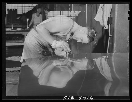 Untitled photo, possibly related to: Sheffield, Alabama. Reynolds Alloys Company. Workman gauging the thickness of a sheet of aluminum which he is rolling