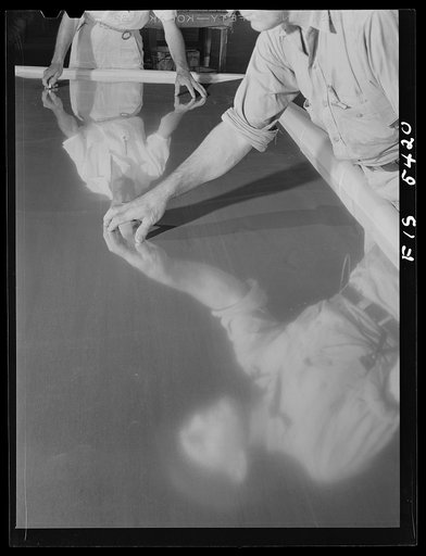 Untitled photo, possibly related to: Sheffield, Alabama. Reynolds Alloys Company. Inspecting aluminum sheets before packing and shipping